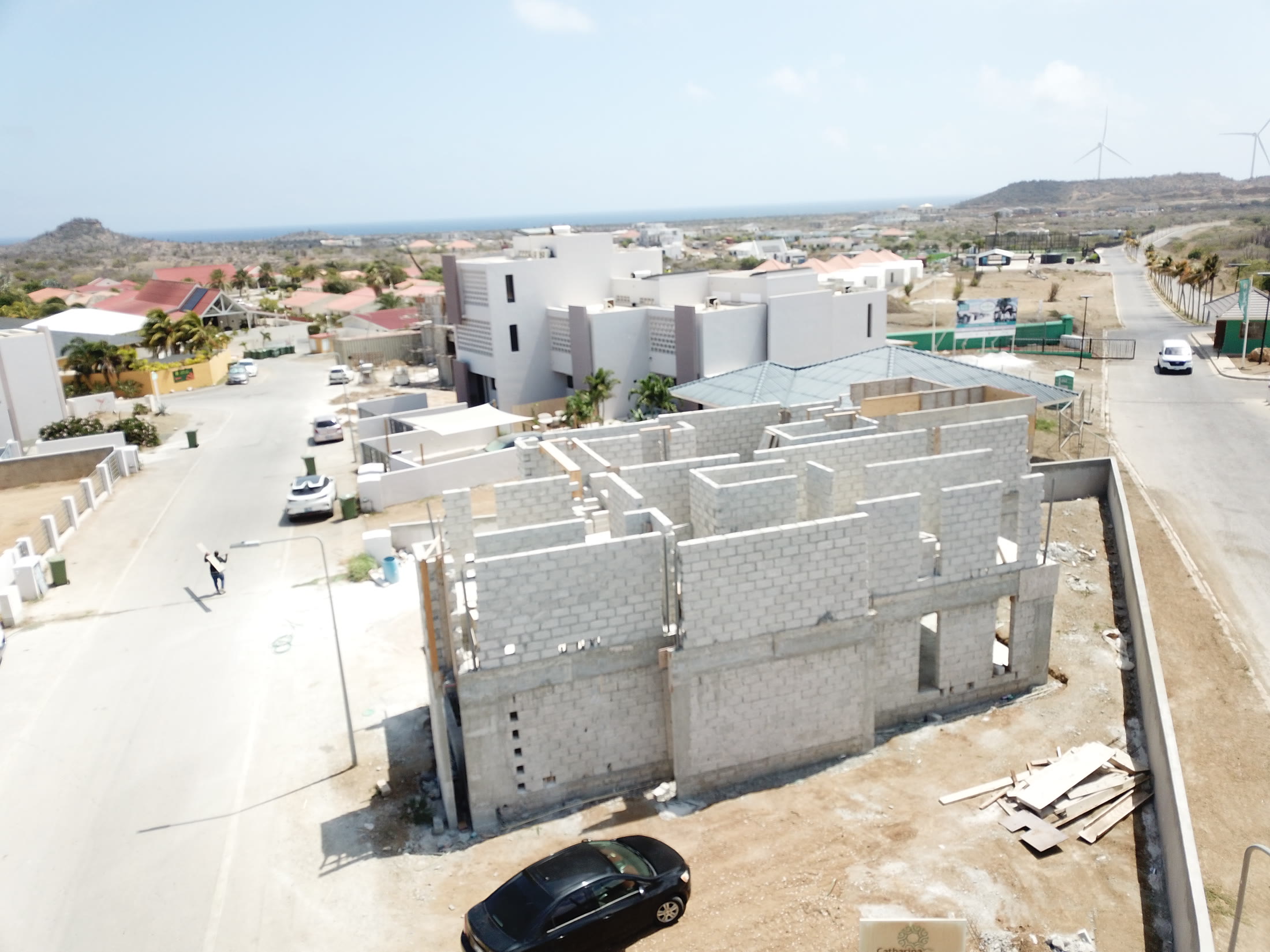 Street level aerial showing a completed block and a new foundation