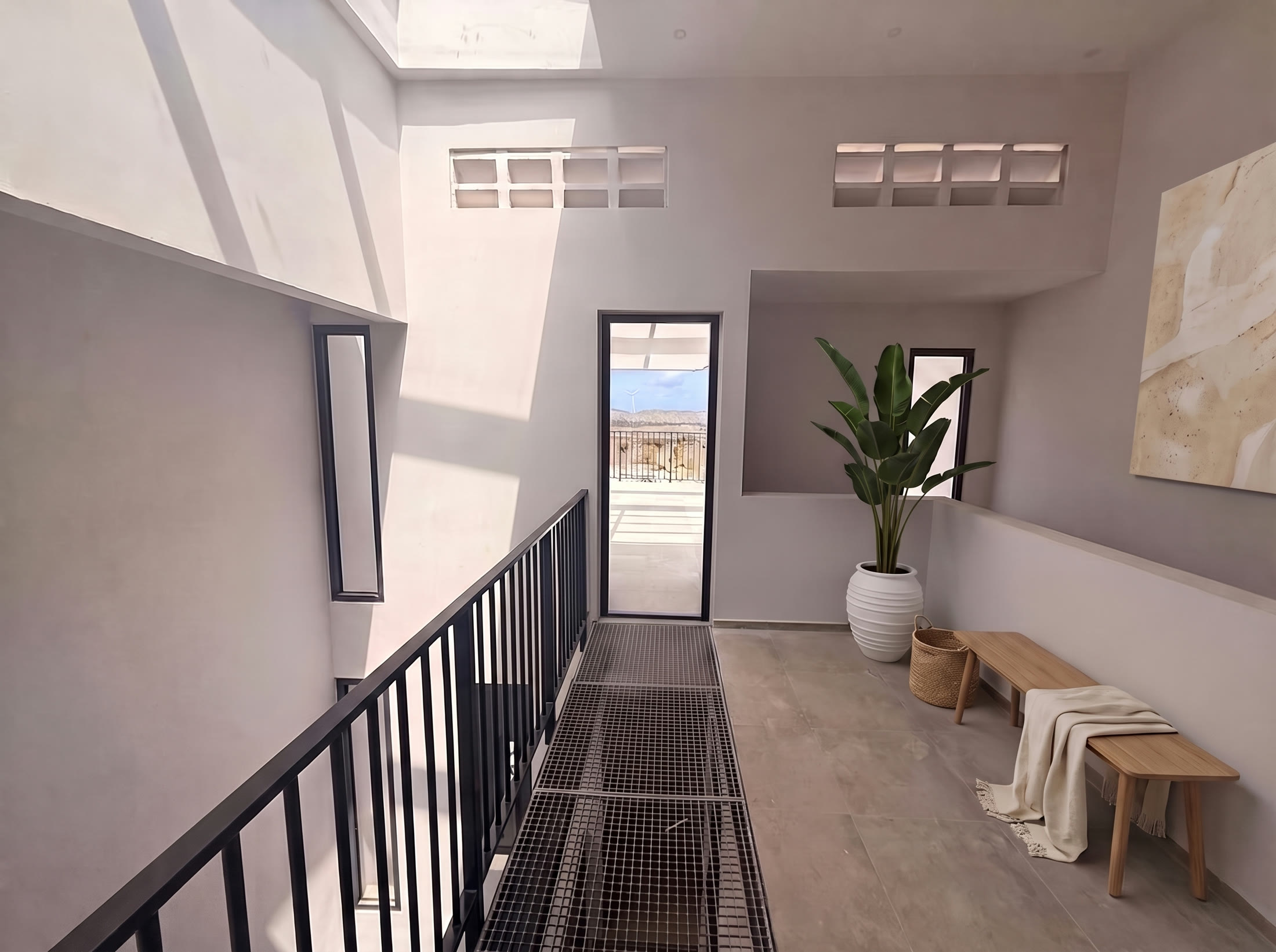First floor gallery with steel grating walkway leading to a terrace door