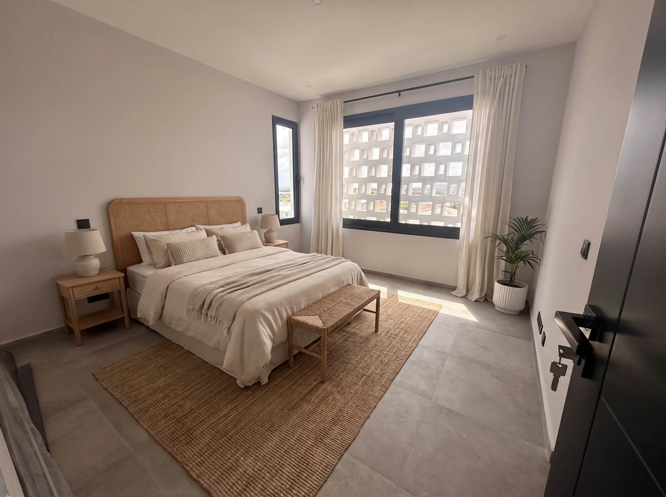Bedroom with rattan headboard, nightstands and jute rug