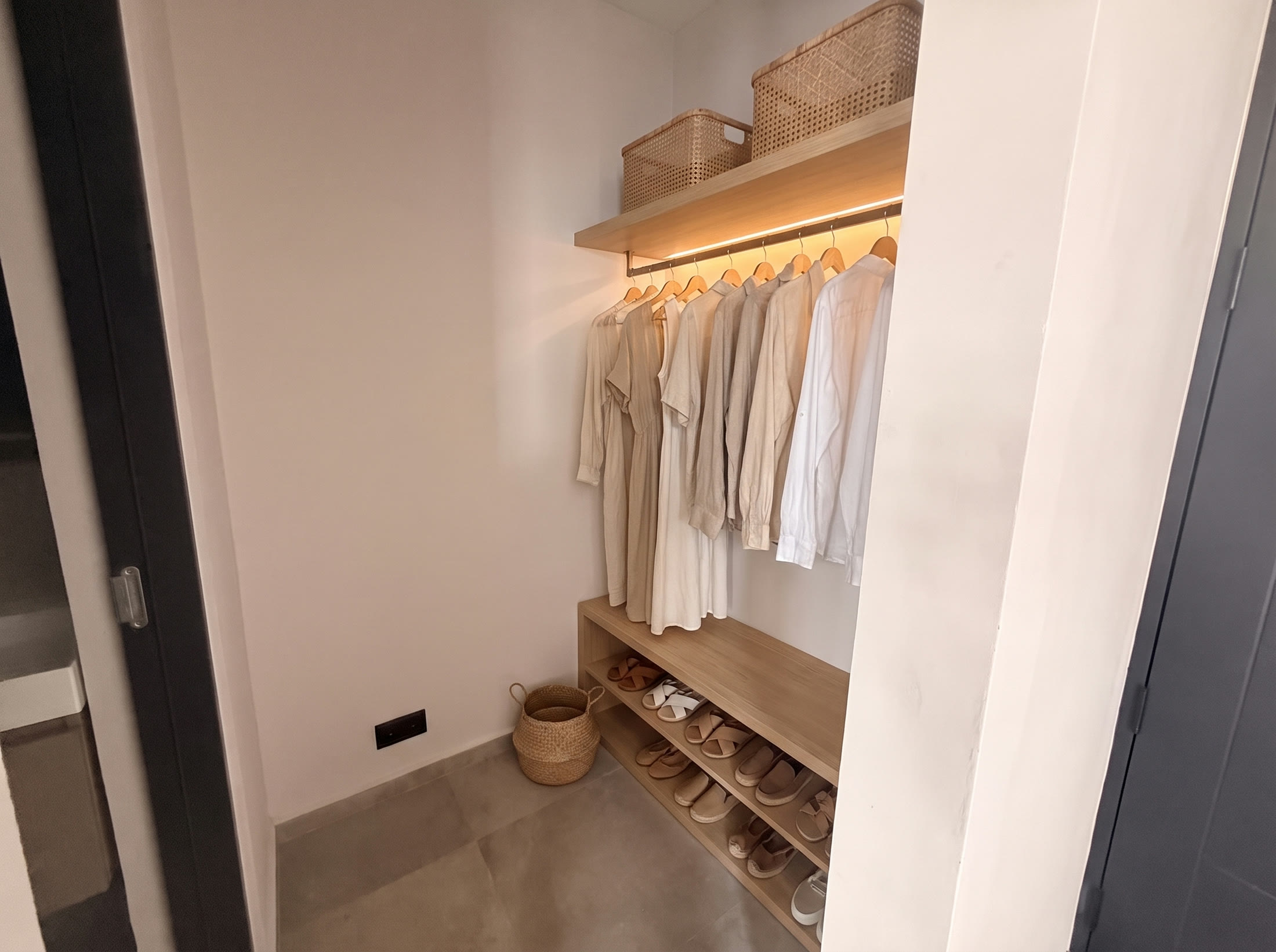 Walk-in closet with oak hanging rail, shelf and shoe rack