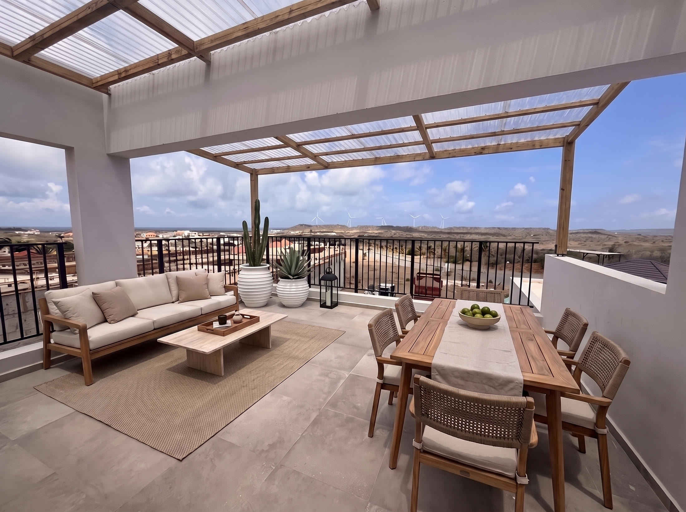 Roof terrace with dining table and panoramic view toward the sea